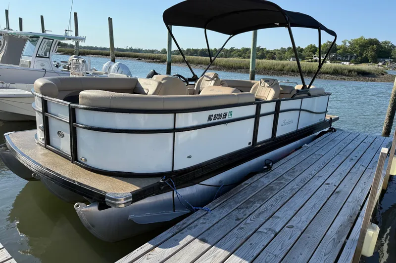 Slide: The Image of 2021 Barletta C22QC pontoon boat docked on a sunny day. - 4