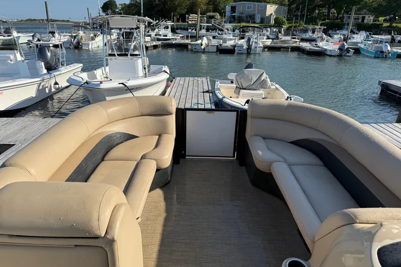 Slide: The Image of Interior view of a 2021 Barletta C22QC pontoon boat docked at a marina. - 7