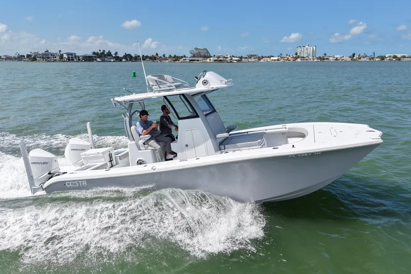 Slide: The Image of 2024 Costa Custom Boats 264HC cruising on open water under clear skies. - 11