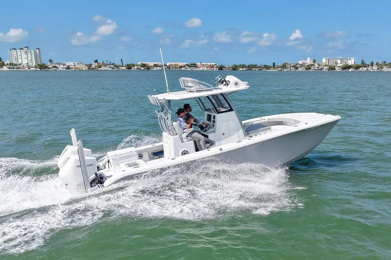 Slide: The Image of 2024 Costa Custom Boats 264HC cruising on a sunny day in coastal waters. - 12