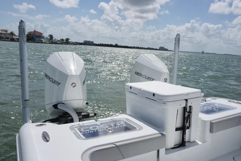 Slide: The Image of 2024 Costa Custom Boats 264HC with dual Mercury engines on open water. - 16