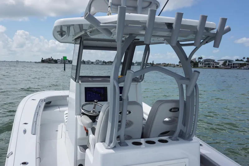 Slide: The Image of 2024 Costa Custom Boats 264HC on water, featuring helm and seating area. - 21