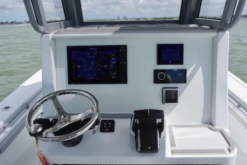 Slide: The Image of 2024 Costa Custom Boats 264HC helm with modern controls and navigation displays. - 23
