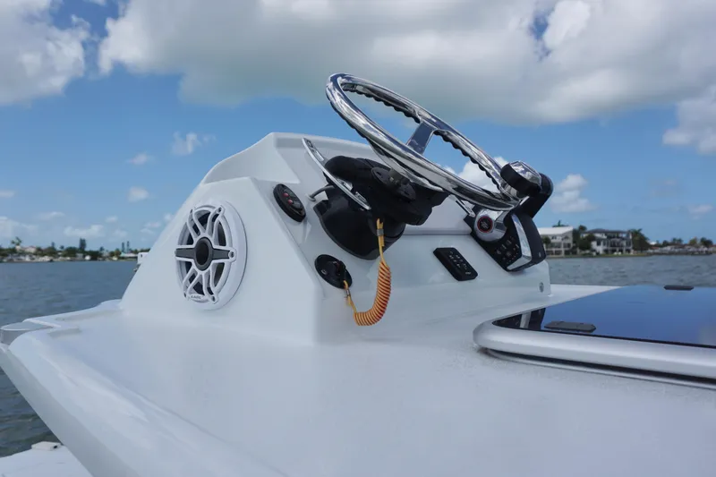 Slide: The Image of Steering console of 2024 Costa Custom Boats 264HC with ocean backdrop. - 28