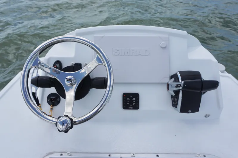 Slide: The Image of Steering console of 2024 Costa Custom Boats 264HC, featuring modern controls and sleek design. - 29
