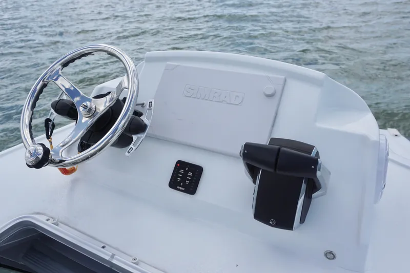 Slide: The Image of Steering console of 2024 Costa Custom Boats 264HC on water. - 30