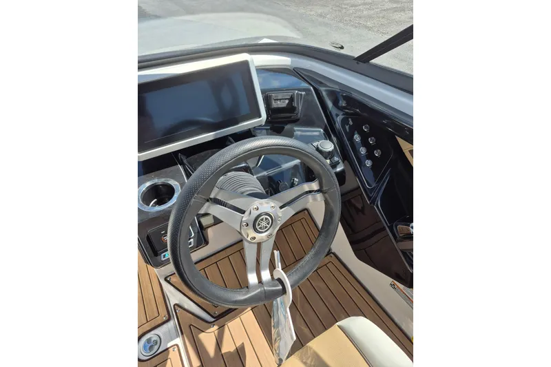 Slide: The Image of 2021 Yamaha Boats 252SE dashboard with steering wheel and touchscreen display. - 12