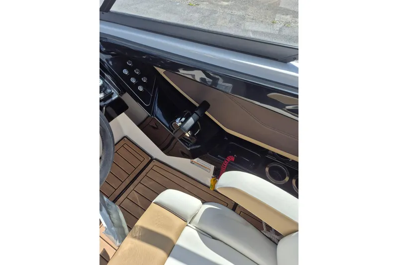 Slide: The Image of Interior cockpit of 2021 Yamaha Boats 252SE, featuring controls and seating. - 13
