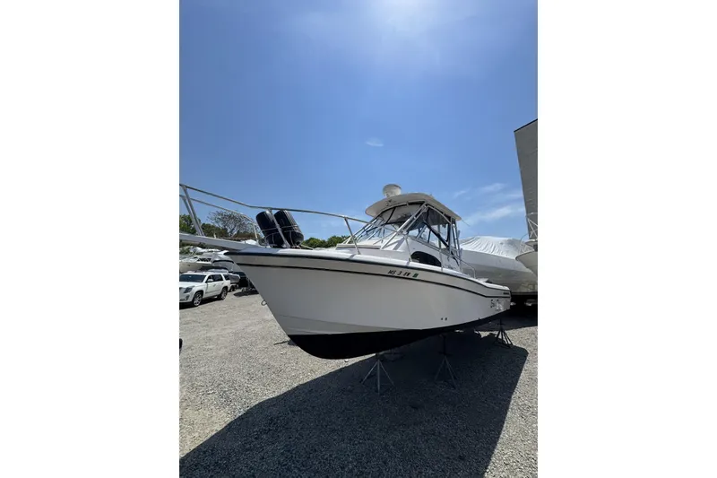 Slide: The Image of 2003 Grady-White Sailfish 282 boat on stands under a clear blue sky. - 1