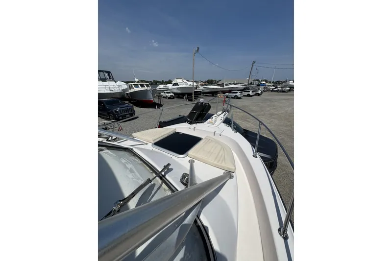 Slide: The Image of 2003 Grady-White Sailfish 282 boat on display in a marina with other vessels. - 10