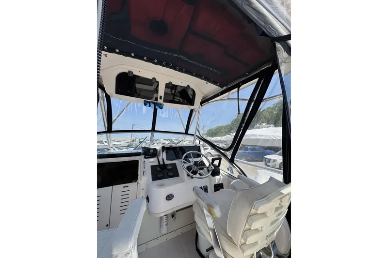 Slide: The Image of 2003 Grady-White Sailfish 282 boat cockpit with steering wheel and controls. - 14