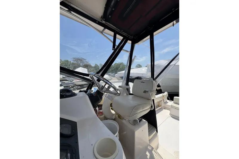 Slide: The Image of Interior view of 2003 Grady-White Sailfish 282 boat cockpit with steering wheel and seat. - 15