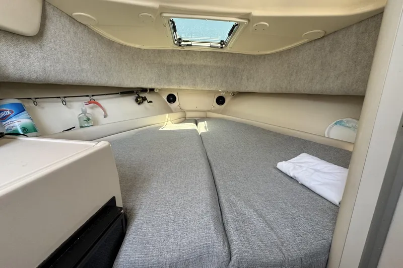 Slide: The Image of 2003 Grady-White Sailfish 282 cabin interior with bed and storage space. - 16