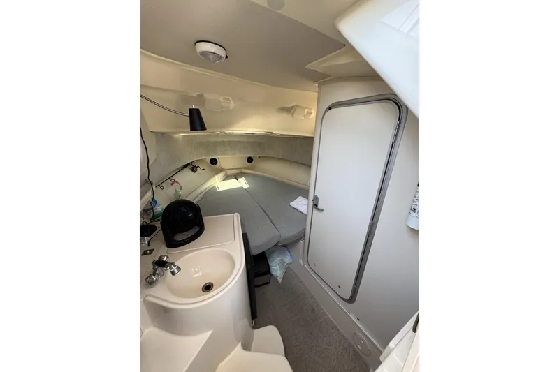 Slide: The Image of 2003 Grady-White Sailfish 282 cabin interior with sink and seating area. - 17