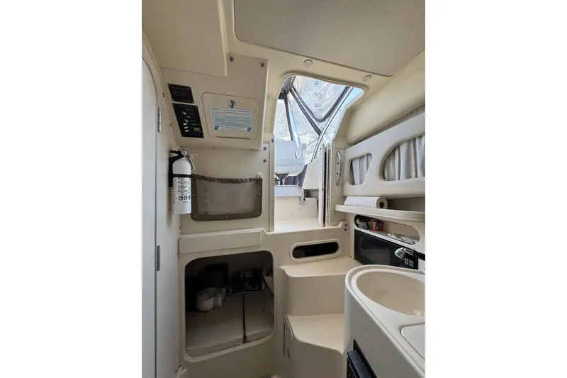 Slide: The Image of Interior of 2003 Grady-White Sailfish 282 boat, featuring compact cabin amenities. - 18