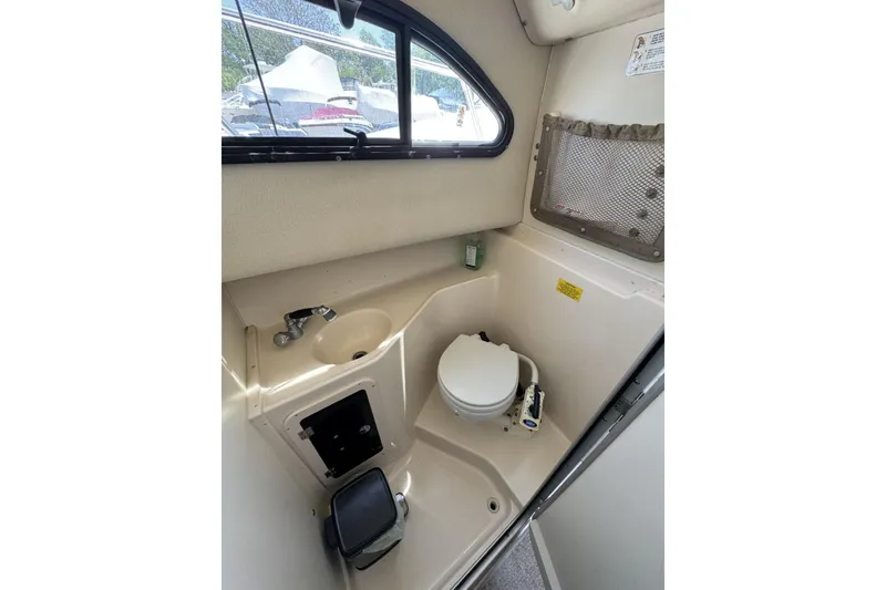 Slide: The Image of 2003 Grady-White Sailfish 282 boat interior with compact bathroom and window view. - 19