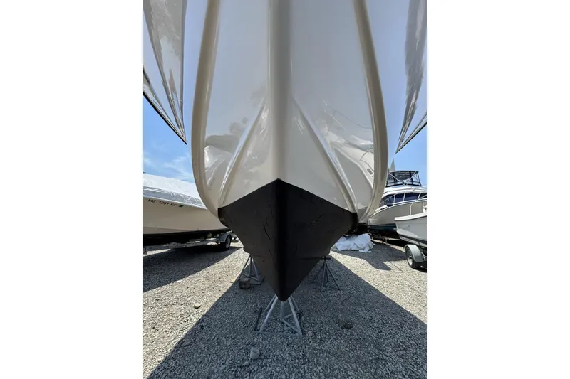 Slide: The Image of 2003 Grady-White Sailfish 282 boat hull on stands, displayed outdoors. - 23