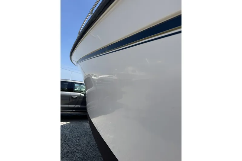 Slide: The Image of Side view of a 2003 Grady-White Sailfish 282 boat with sleek white hull. - 24