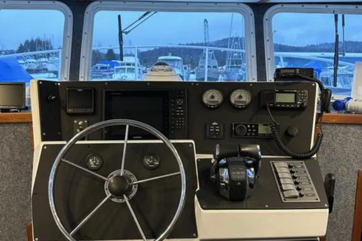Slide: The Image of Helm of 2000 SeaSport Pacific 3200 boat with steering wheel and navigation instruments. - 1