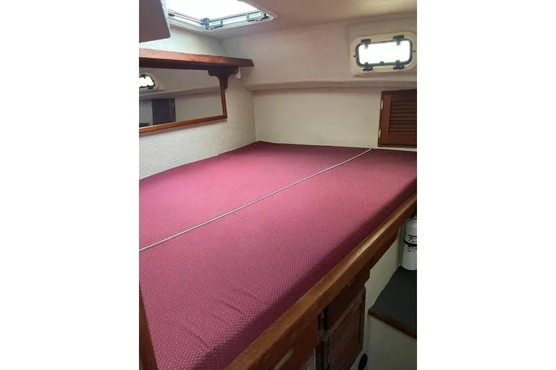 Slide: The Image of Interior cabin of 2001 SeaSport Pacific 3200 with red bedding and wooden accents. - 10
