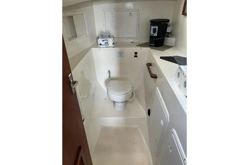 Slide: The Image of 2001 SeaSport Pacific 3200 boat bathroom with toilet and countertop amenities. - 11