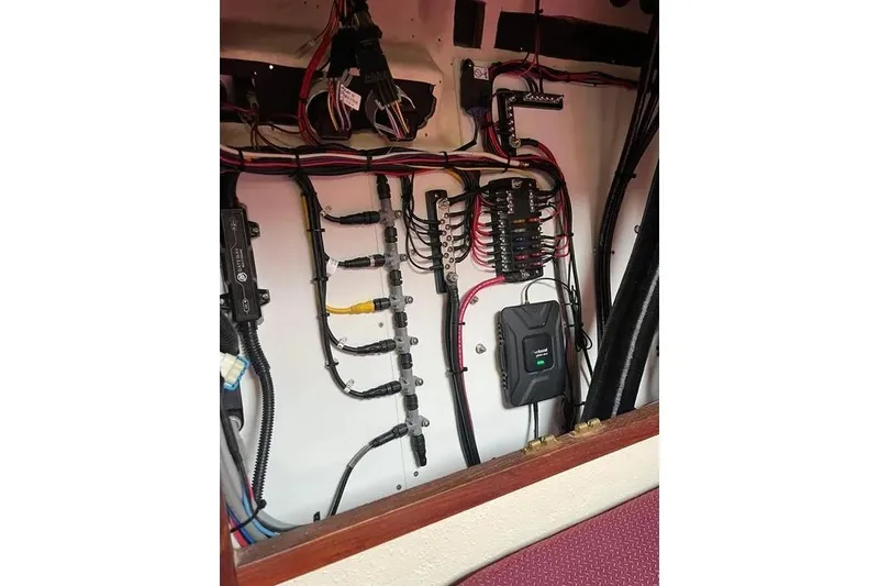 Slide: The Image of Electrical wiring system inside a 2001 SeaSport Pacific 3200 boat, showcasing organized cables and components. - 12