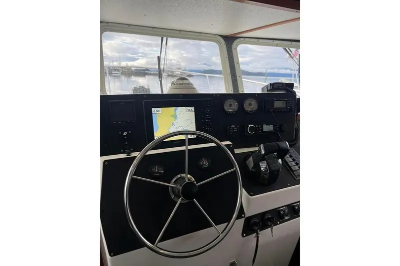 Slide: The Image of Helm of 2001 SeaSport Pacific 3200 boat with navigation equipment and steering wheel. - 2