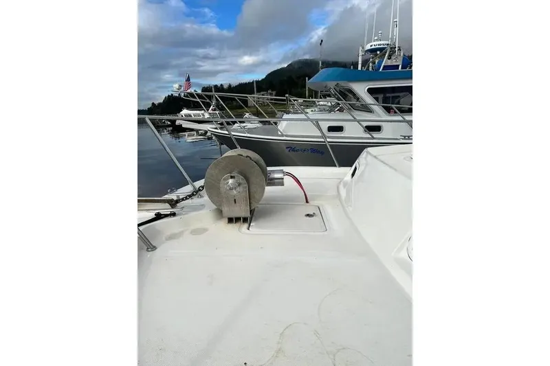 Slide: The Image of 2001 SeaSport Pacific 3200 boat docked in a marina with scenic background. - 20