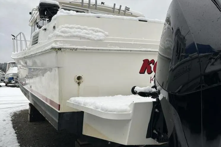 Slide: The Image of SeaSport Pacific 3200 boat, 2000 model, covered in snow, docked outdoors. - 21