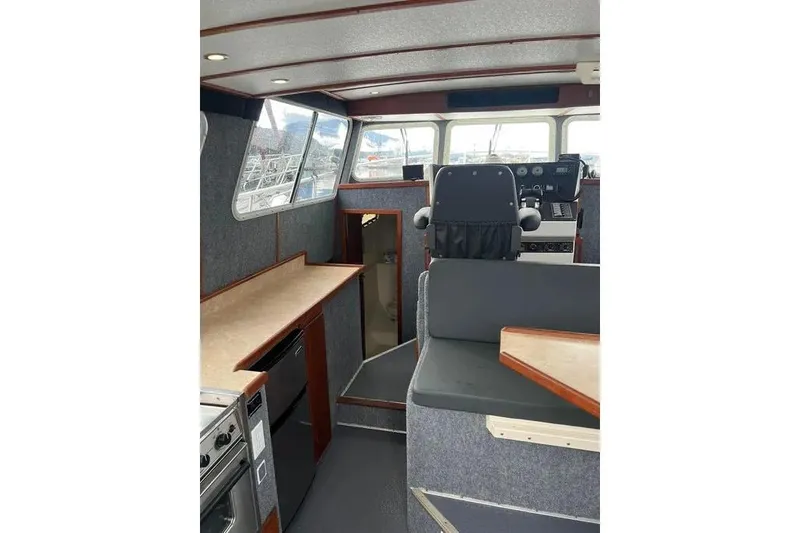 Slide: The Image of Interior of 2001 SeaSport Pacific 3200 boat, featuring helm and seating area. - 4