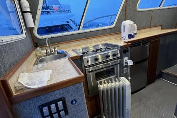 Slide: The Image of Interior of 2000 SeaSport Pacific 3200 boat with kitchen appliances and countertop. - 6