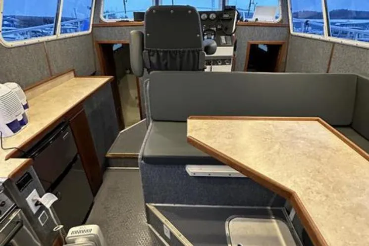 Slide: The Image of Interior of 2000 SeaSport Pacific 3200 boat with seating, table, and helm station. - 8