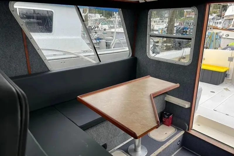 Slide: The Image of Interior of 2001 SeaSport Pacific 3200 boat with seating and table, docked at marina. - 9