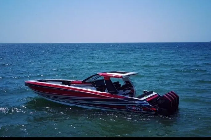 Slide: The Image of 2021 Cigarette 41' Nighthawk boat on open water, featuring sleek red and white design. - 4