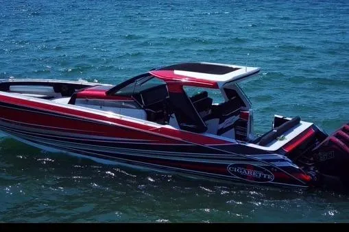 Slide: The Image of 2021 Cigarette 41' Nighthawk boat on water, featuring sleek red and white design. - 6