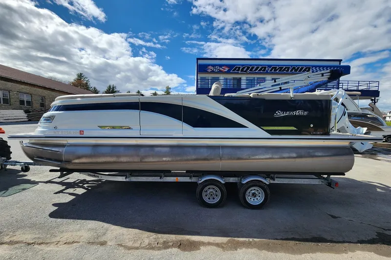 The Image of 2022 Silver Wave 2410 SW5 pontoon boat on trailer under blue sky. - 1