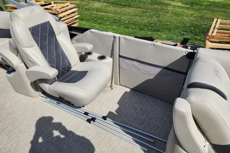 Slide: The Image of Luxurious seating on 2022 Silver Wave 2410 SW5 pontoon boat, featuring plush upholstery and cup holders. - 10