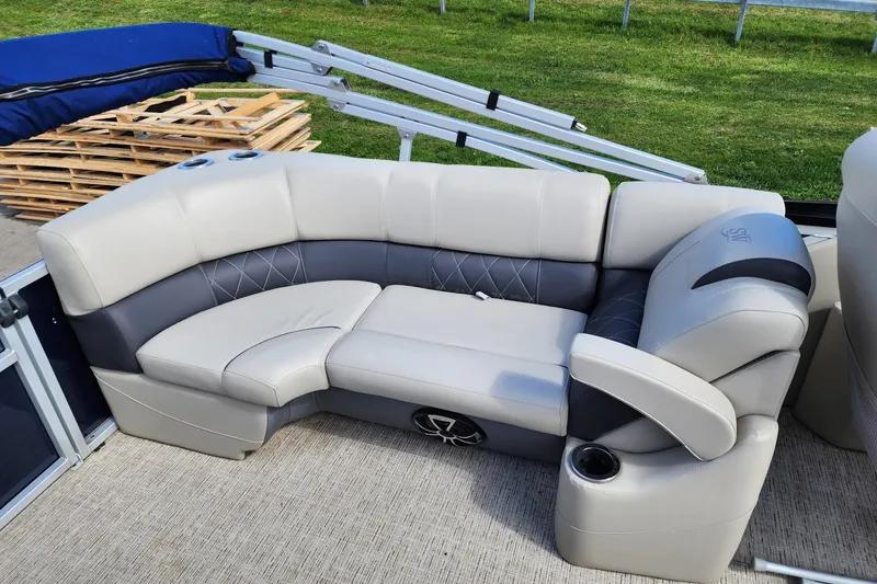 Slide: The Image of Luxurious seating on 2022 Silver Wave 2410 SW5 pontoon boat, featuring plush upholstery and cup holders. - 12