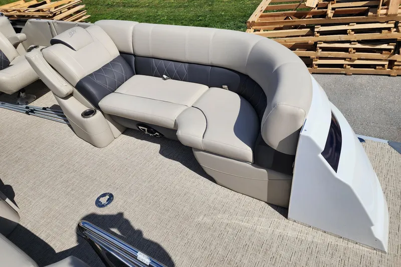 Slide: The Image of Luxurious seating on 2022 Silver Wave 2410 SW5 pontoon boat, featuring plush upholstery and cup holders. - 13