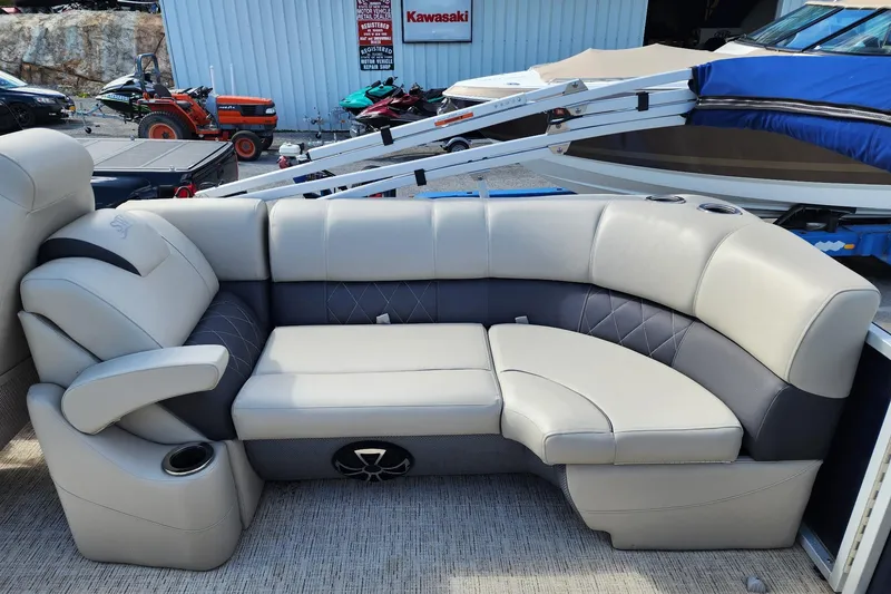 Slide: The Image of Luxurious seating on 2022 Silver Wave 2410 SW5 pontoon boat, featuring plush upholstery and cup holders. - 16