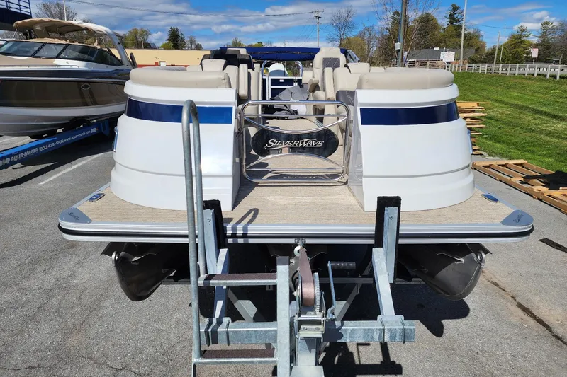 Slide: The Image of 2022 Silver Wave 2410 SW5 pontoon boat on trailer, parked outdoors. - 5