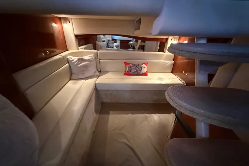 Slide: The Image of Interior of 2003 Sea Ray 340 Sundancer yacht with cozy seating and decorative pillows. - 10
