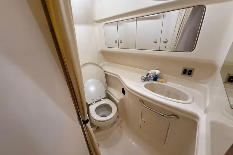 Slide: The Image of Bathroom interior of 2003 Sea Ray 340 Sundancer yacht, featuring toilet and sink. - 12