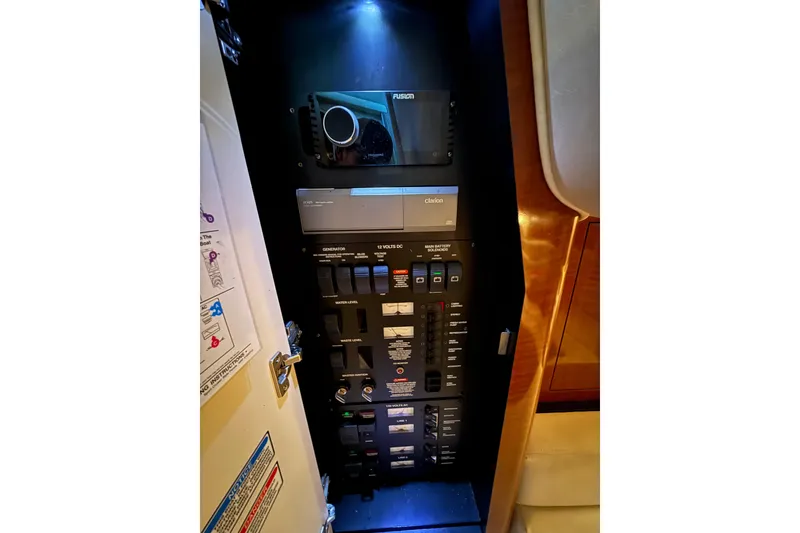 Slide: The Image of Electrical control panel inside a 2003 Sea Ray 340 Sundancer boat, featuring various switches and controls. - 15