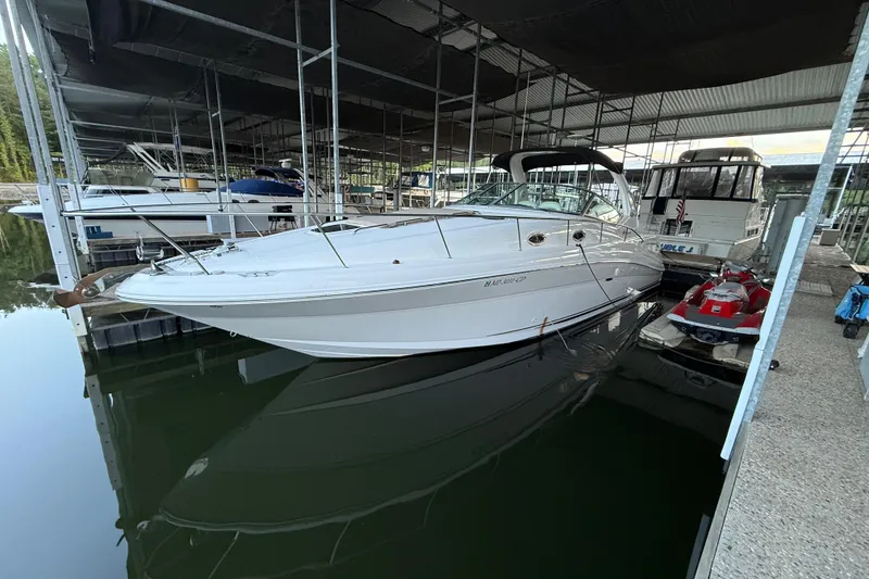 Slide: The Image of 2003 Sea Ray 340 Sundancer docked in a marina, surrounded by other boats. - 3