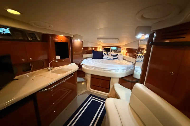 Slide: The Image of Luxurious interior of a 2003 Sea Ray 340 Sundancer yacht with cozy bed and kitchenette. - 8