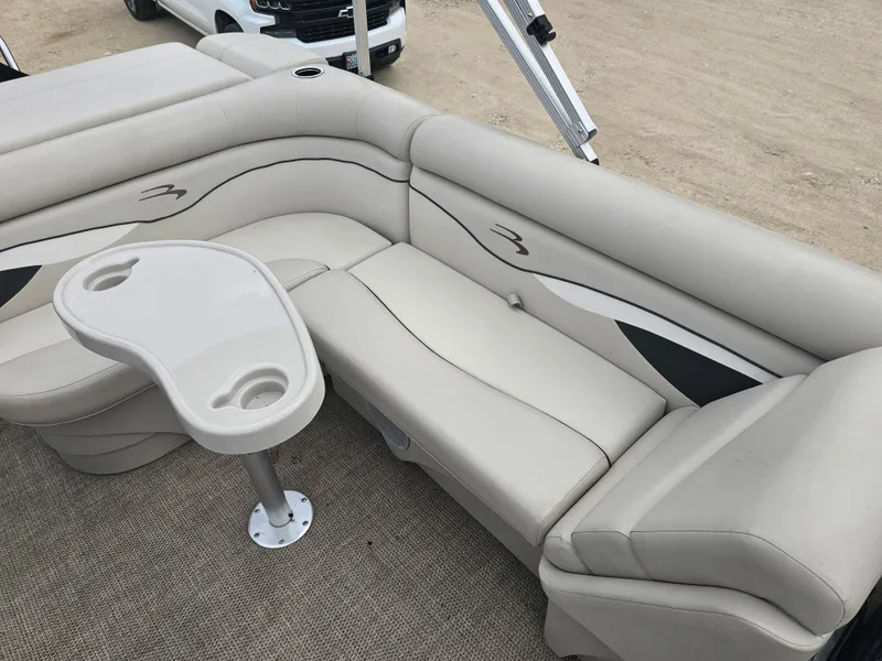 Slide: The Image of Interior of a 2020 Bennington 20SV pontoon boat with beige sofa and table. - 5