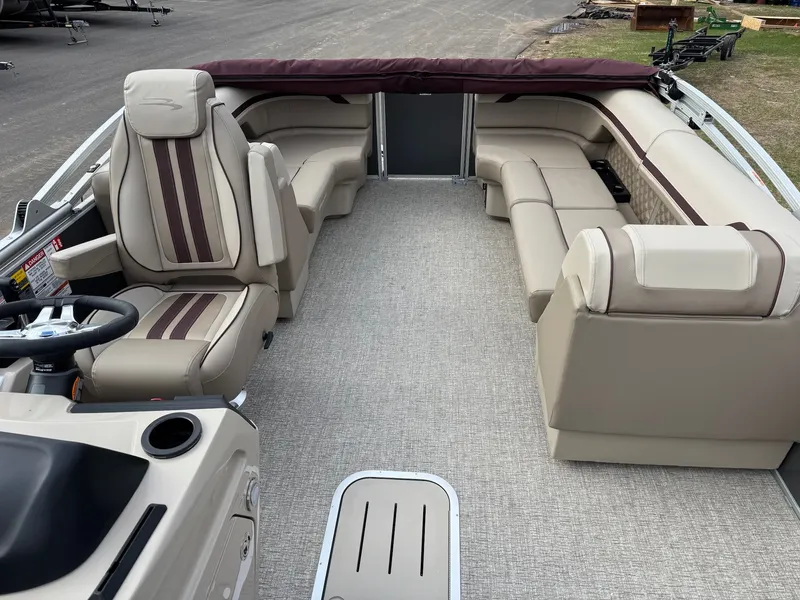 Slide: The Image of Interior of a 2026 Bennington 22SSR-SPS pontoon boat with beige seating. - 13