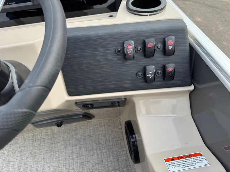 Slide: The Image of Dashboard of 2026 Bennington 22SSR-SPS (PB) with switches and steering wheel. - 18