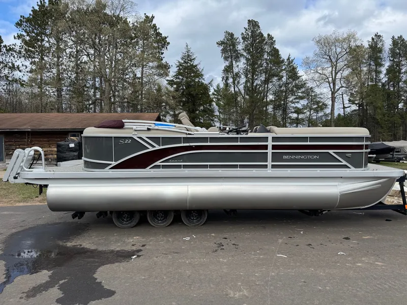 Slide: The Image of 2026 Bennington 22SSR-SPS pontoon boat on trailer outdoors. - 2